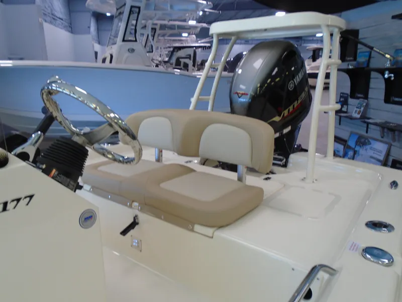 Slide: The Image of 2025 Scout 177 Sport boat interior with steering wheel and seating. - 7