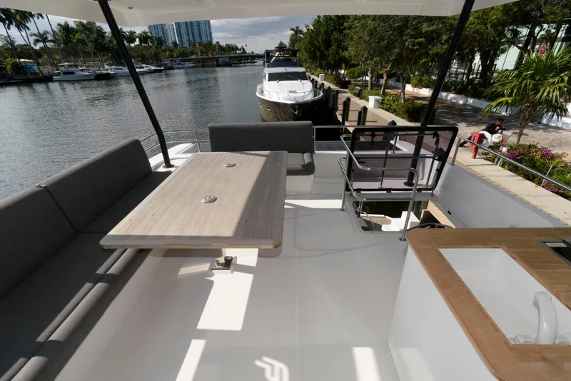 Slide: The Image of 2022 Fountaine Pajot MY6 yacht deck with seating, table, and waterfront view. - 17