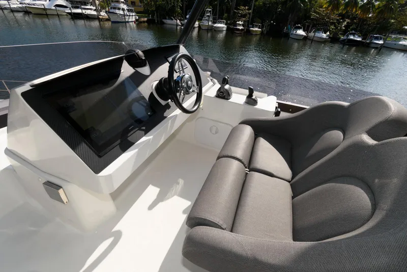 Slide: The Image of 2022 Fountaine Pajot MY6 helm station with plush seating and modern controls. - 20