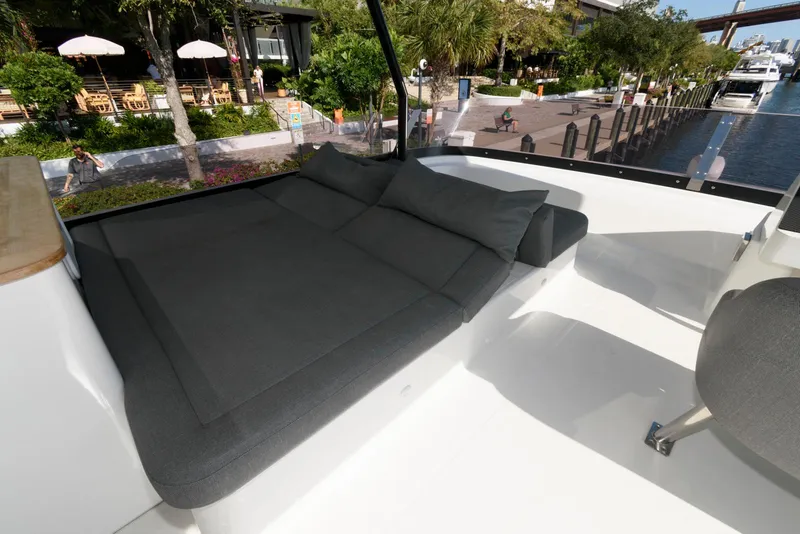 Slide: The Image of Luxury sunbed on 2022 Fountaine Pajot MY6 yacht, docked near waterfront. - 24
