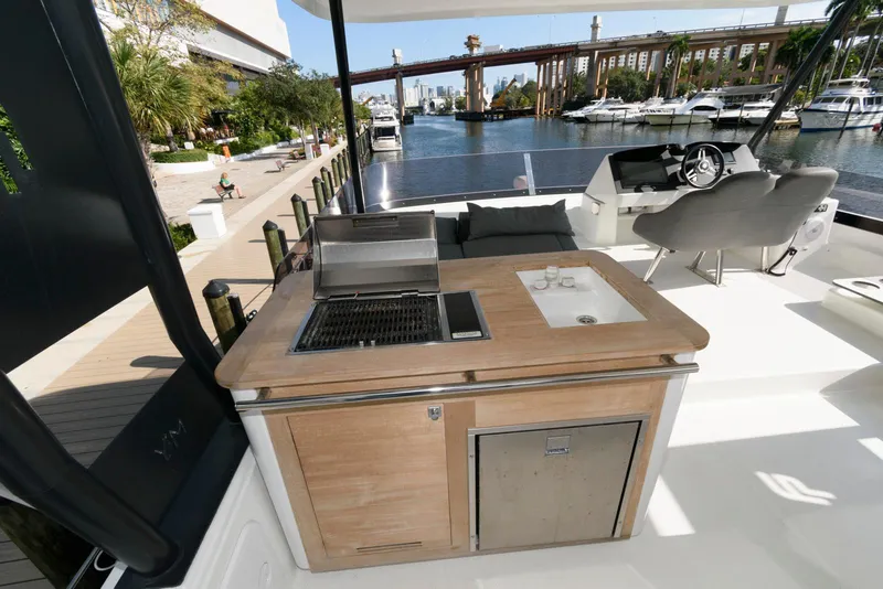 Slide: The Image of Outdoor kitchen on 2022 Fountaine Pajot MY6 yacht, featuring grill and sink by waterfront. - 26