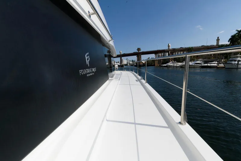 Slide: The Image of 2022 Fountaine Pajot MY6 yacht deck with marina view, showcasing sleek design and luxury. - 28