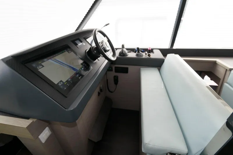 Slide: The Image of 2022 Fountaine Pajot MY6 helm station with modern controls and navigation display. - 33
