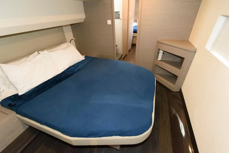 Slide: The Image of 2022 Fountaine Pajot MY6 cabin with blue bedding and modern interior design. - 44