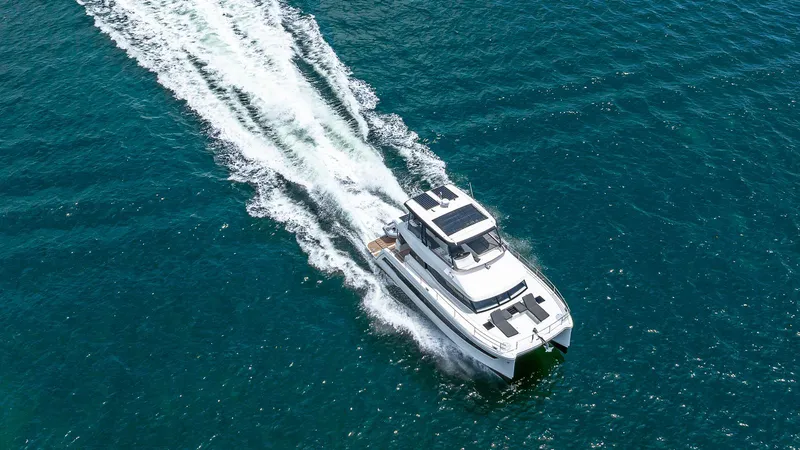 Slide: The Image of 2022 Fountaine Pajot MY6 cruising on clear blue water, aerial view. - 7