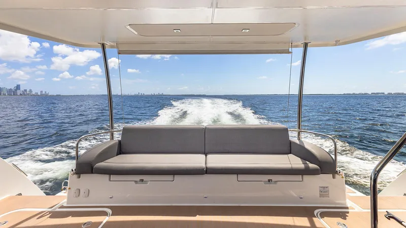 Slide: The Image of 2022 Fountaine Pajot MY6 yacht, rear view with ocean and city skyline. - 8