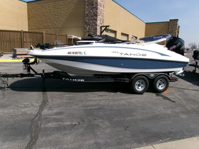 Slide: The Image of 2023 Tahoe 1950 boat on trailer, parked outdoors, side view. - 3