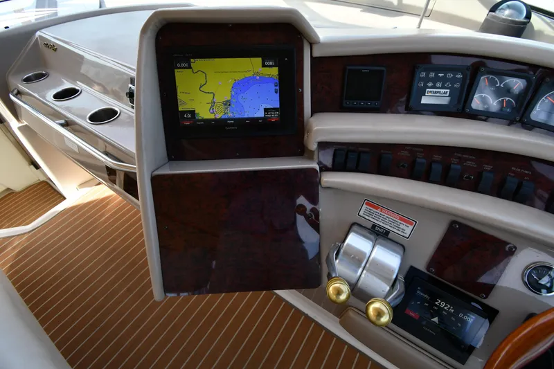 Slide: The Image of 1998 Sea Ray 500 Sundancer helm with navigation display and control panel. - 12
