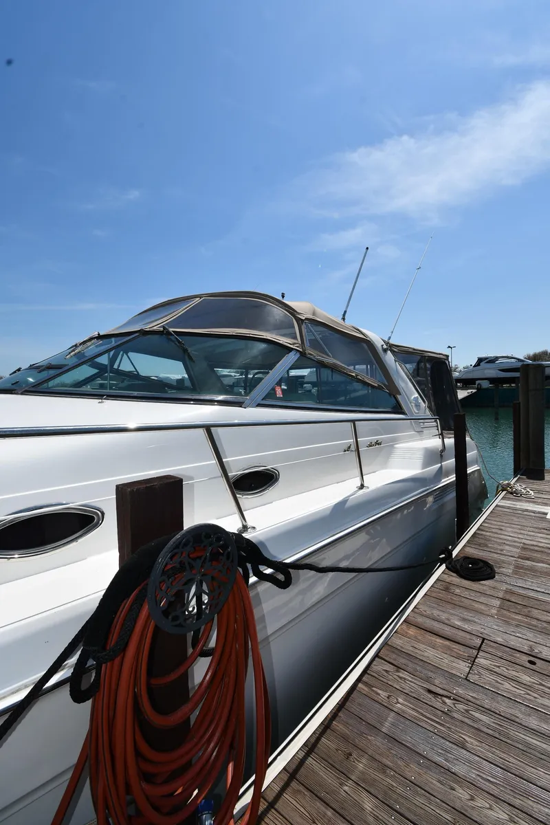Slide: The Image of 1998 Sea Ray 500 Sundancer docked under clear blue sky. - 2