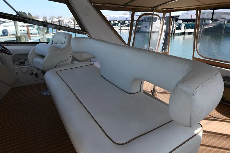 Slide: The Image of 1998 Sea Ray 500 Sundancer interior with white seating and marina view. - 20