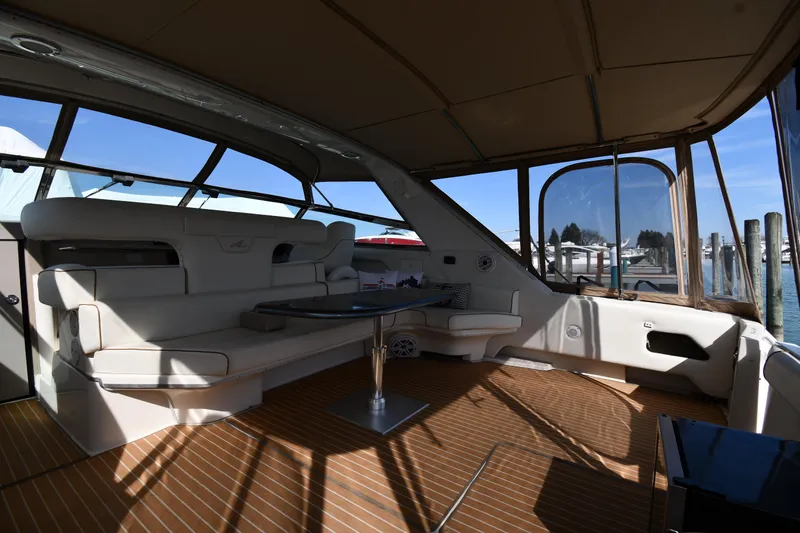Slide: The Image of Interior of 1998 Sea Ray 500 Sundancer yacht with seating and table, docked at marina. - 21