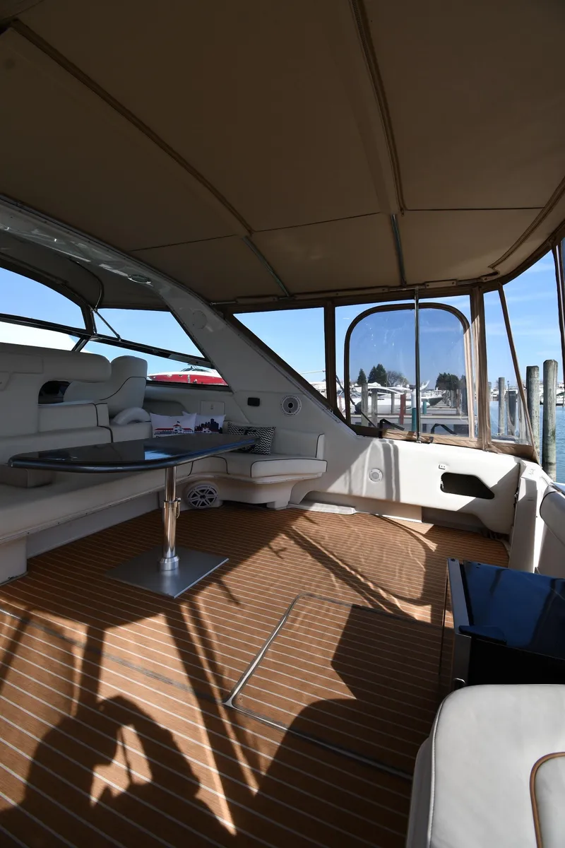 Slide: The Image of 1998 Sea Ray 500 Sundancer yacht interior with seating and wooden flooring. - 22