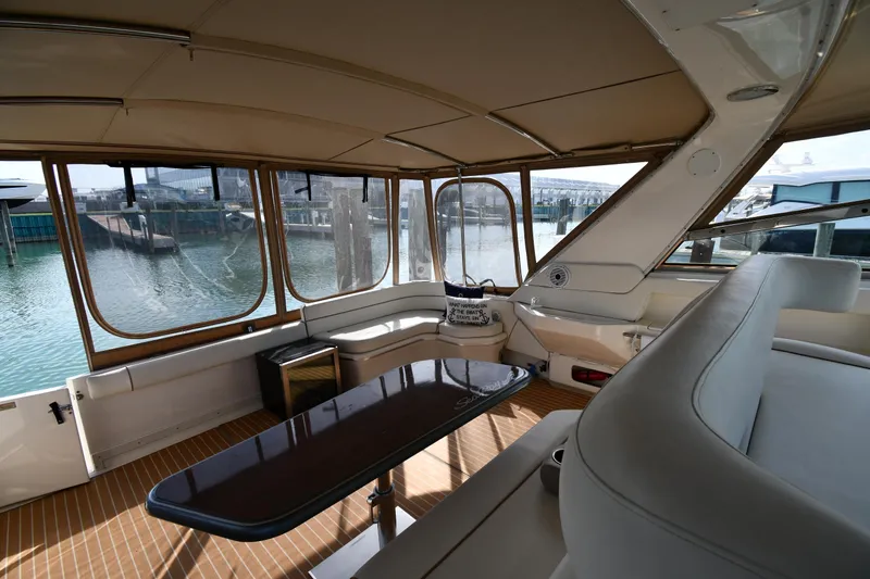 Slide: The Image of 1998 Sea Ray 500 Sundancer interior with elegant seating and waterfront view. - 25