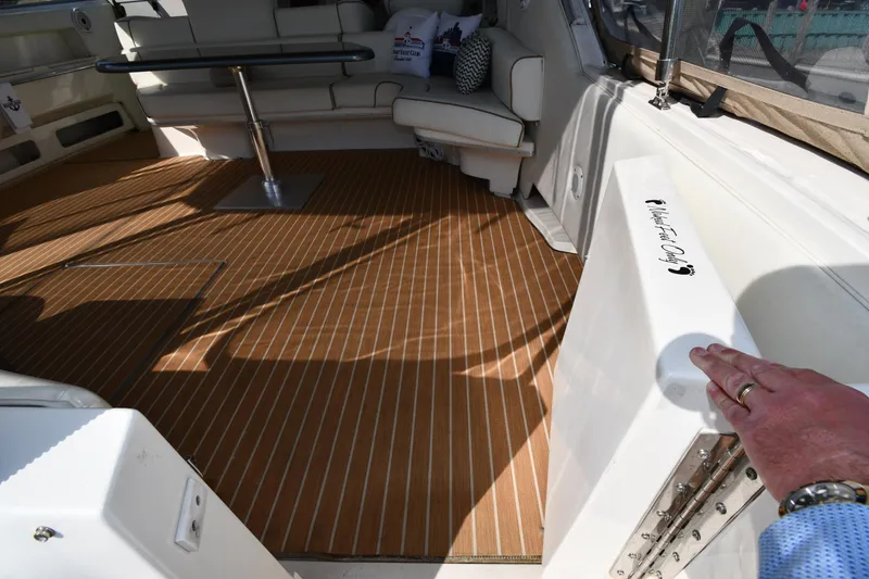 Slide: The Image of 1998 Sea Ray 500 Sundancer interior with wood flooring and white seating. - 28