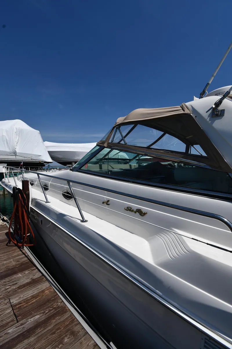Slide: The Image of 1998 Sea Ray 500 Sundancer yacht docked under clear blue sky. - 3