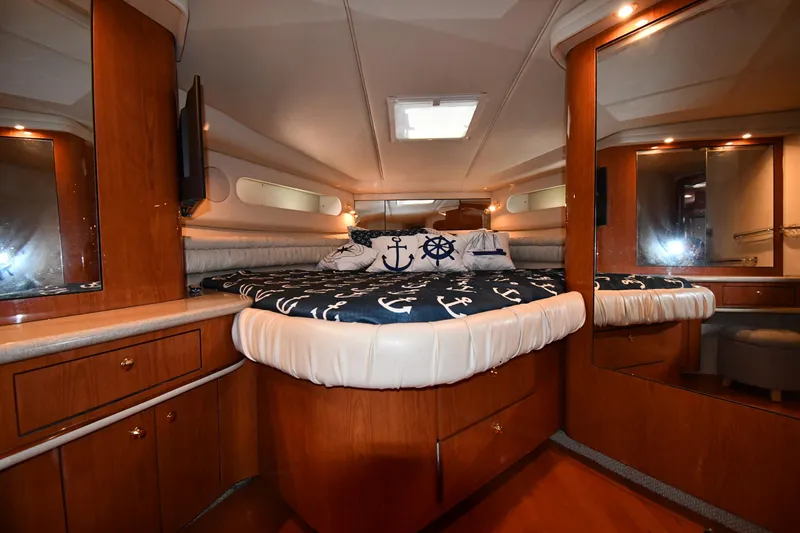 Slide: The Image of Luxurious cabin interior of 1998 Sea Ray 500 Sundancer yacht with nautical-themed bedding. - 32