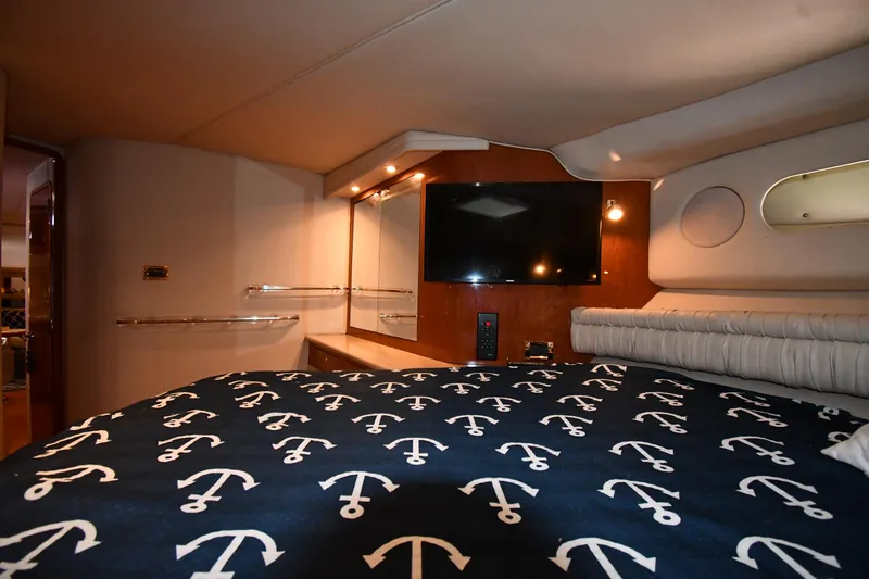 Slide: The Image of Luxurious cabin interior of 1998 Sea Ray 500 Sundancer with anchor-themed bedding. - 35