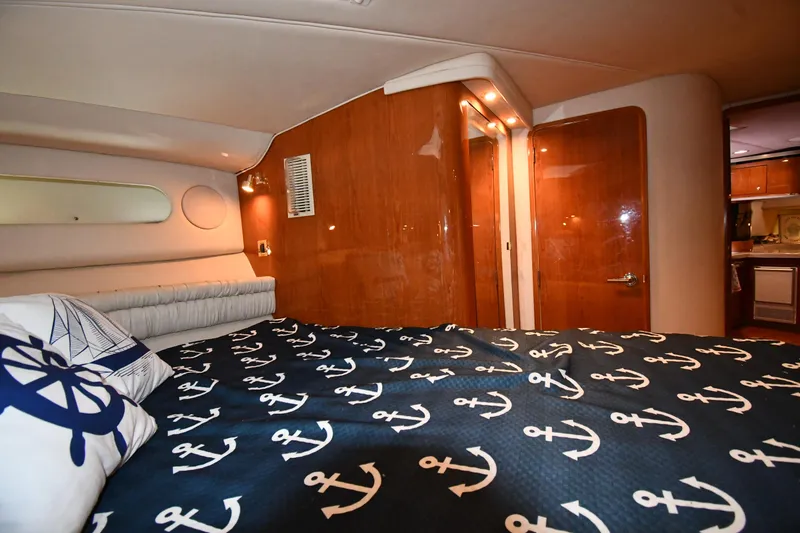 Slide: The Image of Interior cabin of 1998 Sea Ray 500 Sundancer with nautical-themed bedding. - 36
