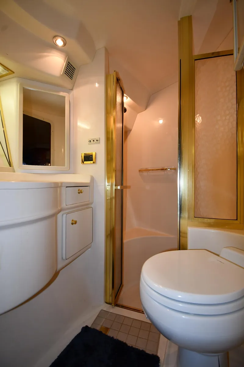 Slide: The Image of Luxurious bathroom in 1998 Sea Ray 500 Sundancer yacht with gold accents and modern fixtures. - 38