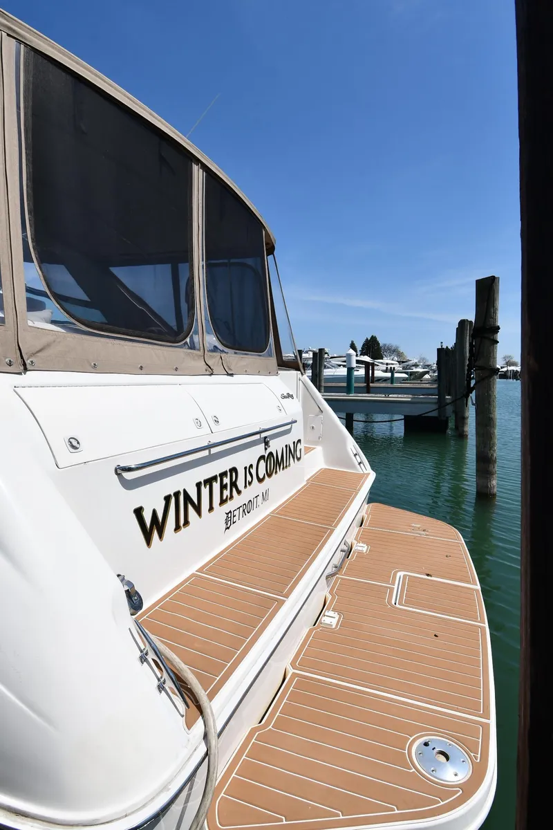 Slide: The Image of 1998 Sea Ray 500 Sundancer docked, featuring "Winter is Coming" text on the stern. - 4