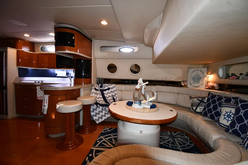 Slide: The Image of Luxurious interior of 1998 Sea Ray 500 Sundancer yacht with elegant seating and kitchen area. - 40