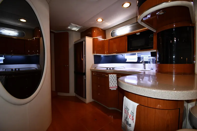 Slide: The Image of Luxurious interior of a 1998 Sea Ray 500 Sundancer yacht with modern kitchen amenities. - 46