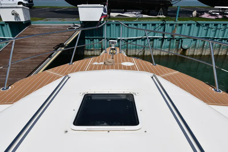 Slide: The Image of 1998 Sea Ray 500 Sundancer yacht deck with wooden finish, docked at marina. - 6