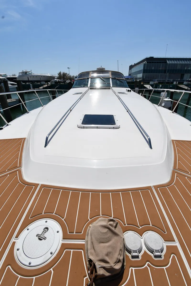 Slide: The Image of 1998 Sea Ray 500 Sundancer yacht with sleek deck design, docked at marina. - 9