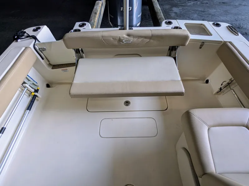 Slide: The Image of 2022 Scout 215 Dorado boat interior with beige seating and storage compartments. - 10