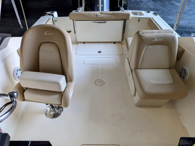 Slide: The Image of 2022 Scout 215 Dorado boat interior with beige seating and spacious deck area. - 11