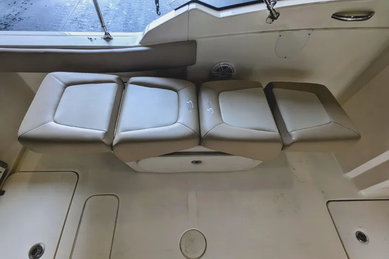 Slide: The Image of 2022 Scout 215 Dorado boat interior seating, beige cushioned seats. - 12