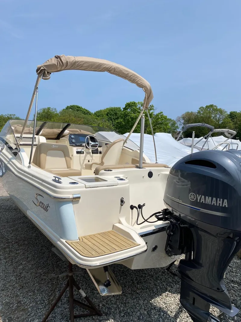 Slide: The Image of 2022 Scout 215 Dorado boat with Yamaha outboard motor, parked on gravel. - 13