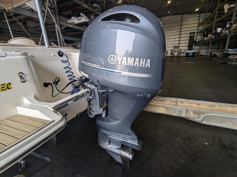 Slide: The Image of Yamaha outboard motor on 2022 Scout 215 Dorado boat in storage facility. - 18