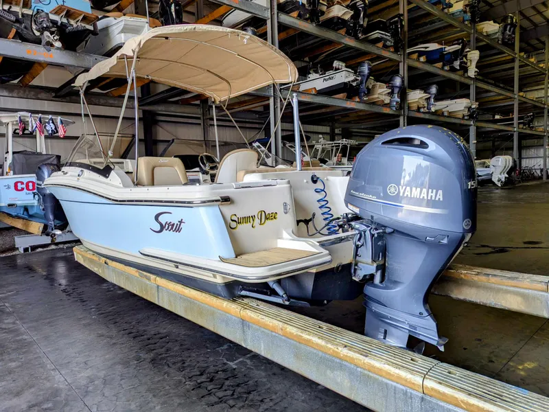 Slide: The Image of 2022 Scout 215 Dorado boat with Yamaha engine in storage facility. - 2