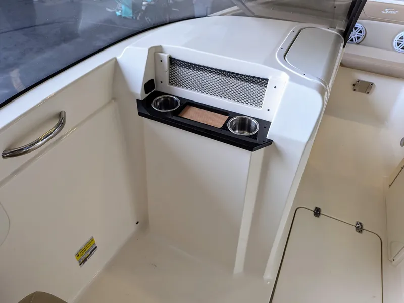 Slide: The Image of 2022 Scout 215 Dorado interior with cup holders and storage compartment. - 7