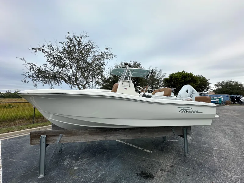 Slide: The Image of 2025 Pioneer 180 Islander boat on display, white hull, outdoor setting. - 1