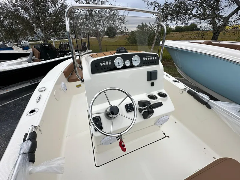 Slide: The Image of 2025 Pioneer 180 Islander boat interior with steering wheel and control panel. - 4