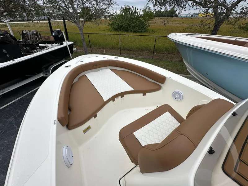 Slide: The Image of 2025 Pioneer 180 Islander boat with tan and white seating in the bow area. - 5