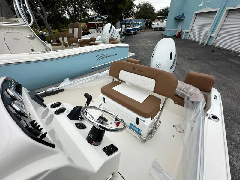 Slide: The Image of 2025 Pioneer 180 Islander boat interior with steering console and seating. - 6