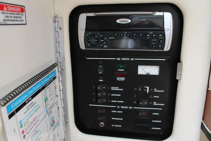 Slide: The Image of Control panel of a 2003 Sea Ray 260 Sundancer boat, featuring various switches and gauges. - 13