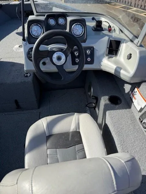 Slide: The Image of Interior of a 2017 Tracker PGV175 boat showing steering wheel and dashboard controls. - 3