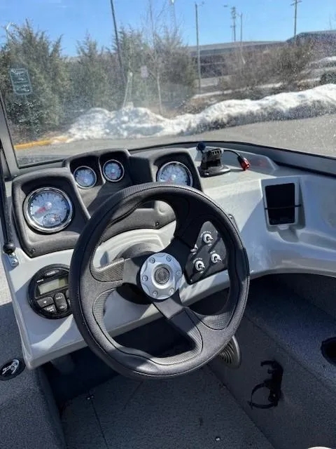 Slide: The Image of 2017 Tracker PGV175 boat dashboard with steering wheel and gauges. - 4