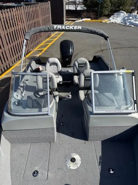 Slide: The Image of 2017 Tracker PGV175 boat with dual consoles and seating, parked outdoors. - 5