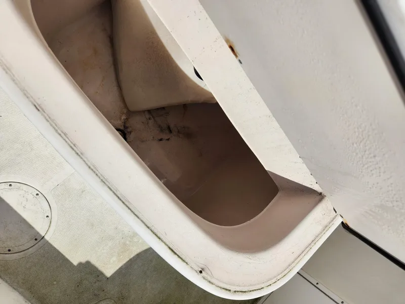 Slide: The Image of 2007 Clearwater 23cc boat interior storage compartment, showing wear and dirt. - 12
