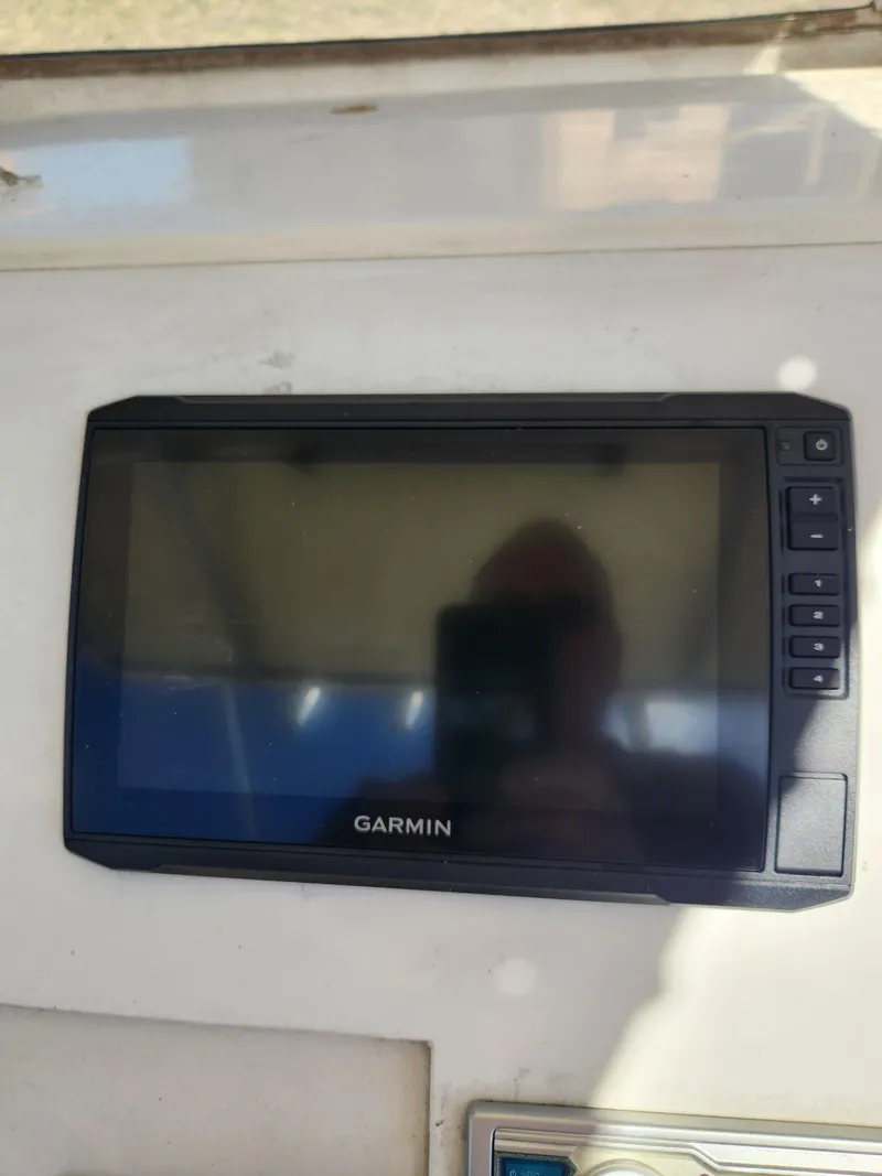 Slide: The Image of Garmin marine GPS device on 2007 Clearwater 23cc boat dashboard. - 13