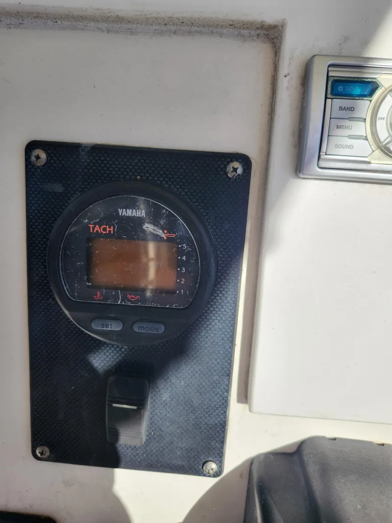 Slide: The Image of Close-up of a Yamaha tachometer on a 2007 Clearwater 23cc boat dashboard. - 15