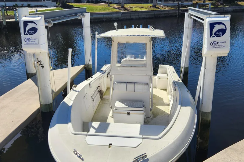 Slide: The Image of 2007 Clearwater 23cc boat docked at marina with lift system. - 2