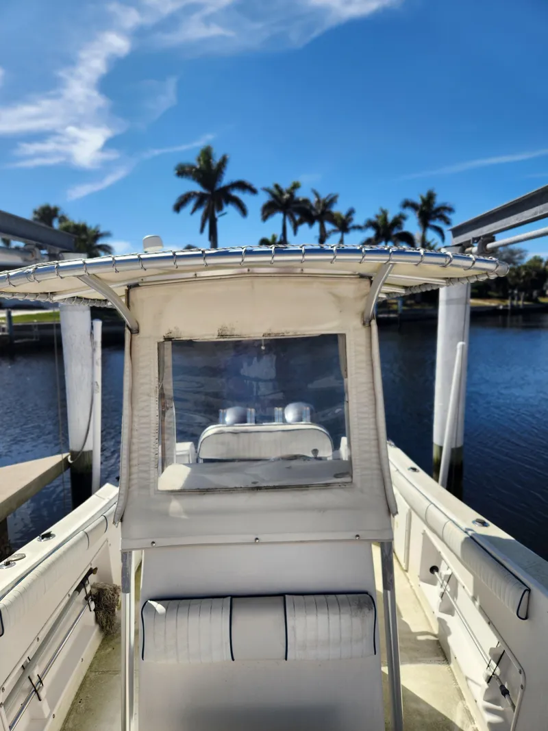 Slide: The Image of 2007 Clearwater 23cc boat docked by a scenic waterfront with palm trees. - 7