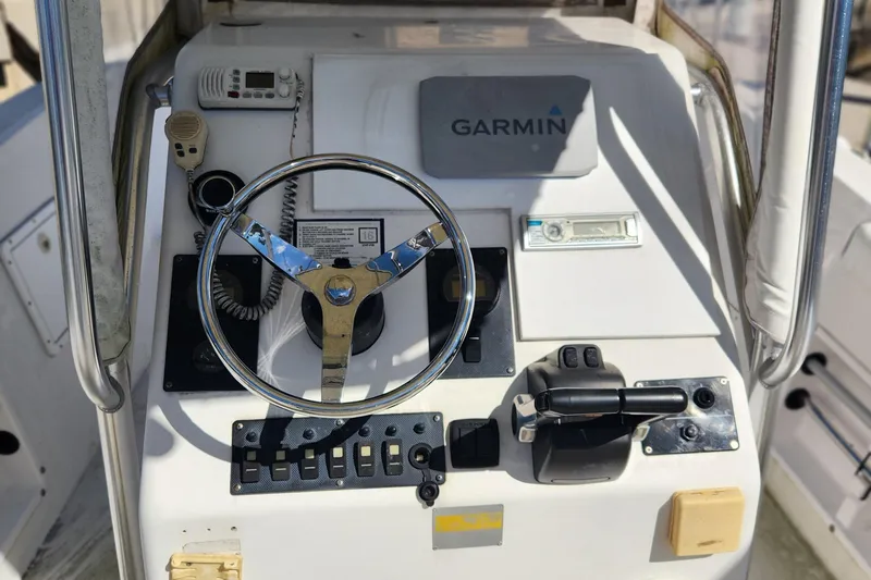 Slide: The Image of 2007 Clearwater 23cc boat console with Garmin GPS, steering wheel, and controls. - 9