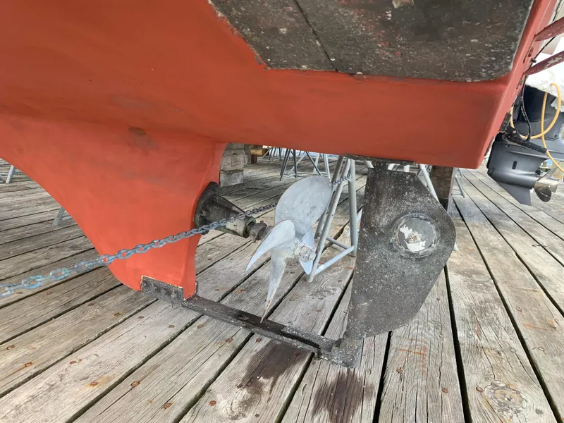 Slide: The Image of 2006 Albin 28 Tournament Express propeller and rudder on wooden dock. - 11